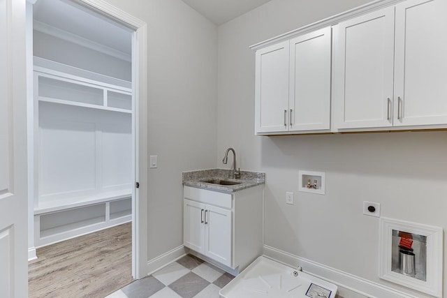 laundry room featuring washer hookup, sink, cabinets, and hookup for an electric dryer