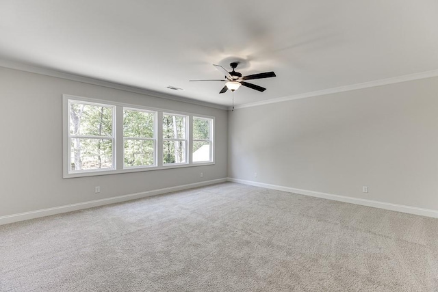 unfurnished room featuring crown molding, light colored carpet, and ceiling fan