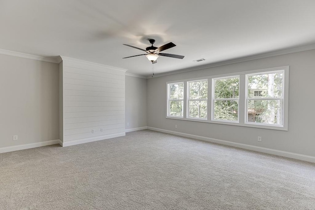 carpeted empty room with crown molding and ceiling fan