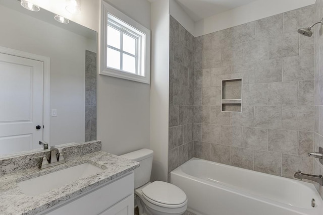 full bathroom with vanity, toilet, and tiled shower / bath combo