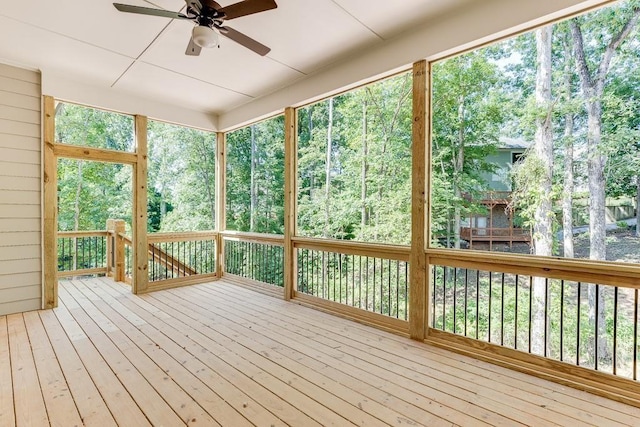 unfurnished sunroom featuring ceiling fan