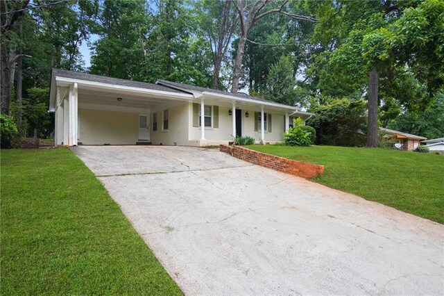 ranch-style house featuring a carport and a front yard