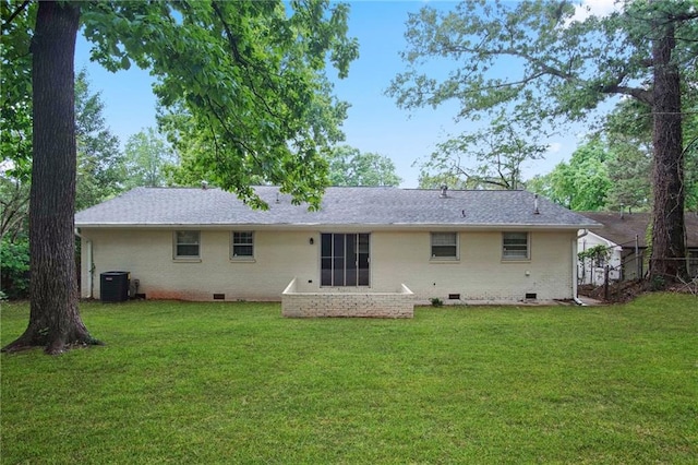 rear view of house featuring brick siding, crawl space, cooling unit, and a lawn