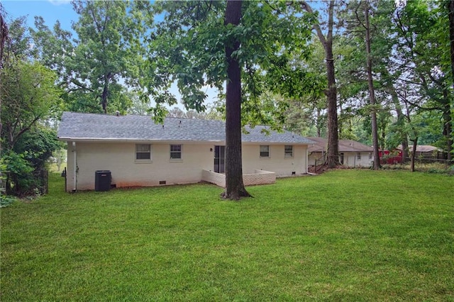 back of house with crawl space, central air condition unit, fence, and a lawn