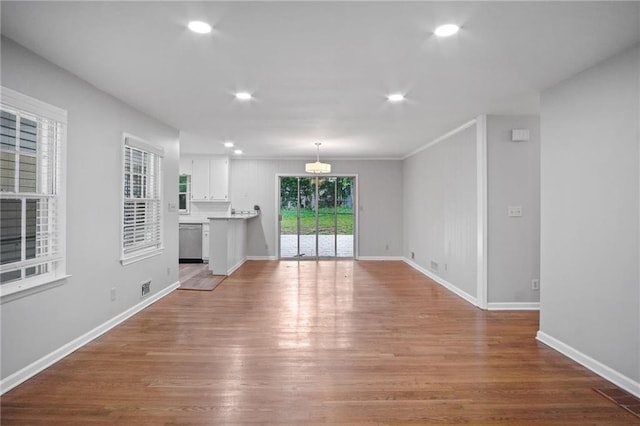 unfurnished living room with recessed lighting, visible vents, baseboards, and wood finished floors