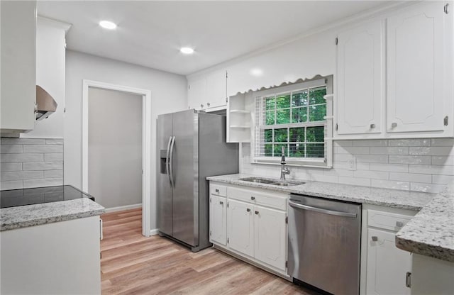 kitchen with open shelves, stainless steel appliances, white cabinetry, a sink, and light wood-type flooring