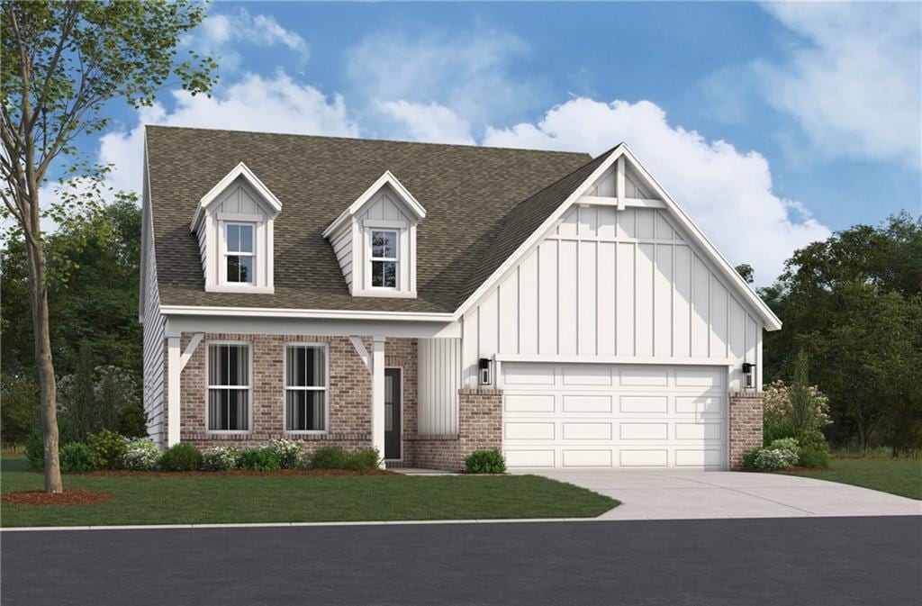 164 Henley St, Canton, GA 30114 - view of front facade featuring board and batten siding, brick siding, concrete driveway, and a garage