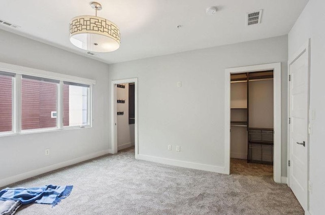 1672 Dekalb Ave NE Unit 2, Atlanta, GA 30307 - unfurnished bedroom featuring carpet, a walk in closet, baseboards, and a closet