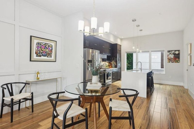1672 Dekalb Ave NE Unit 2, Atlanta, GA 30307 - dining space featuring a chandelier, light wood-type flooring, and baseboards