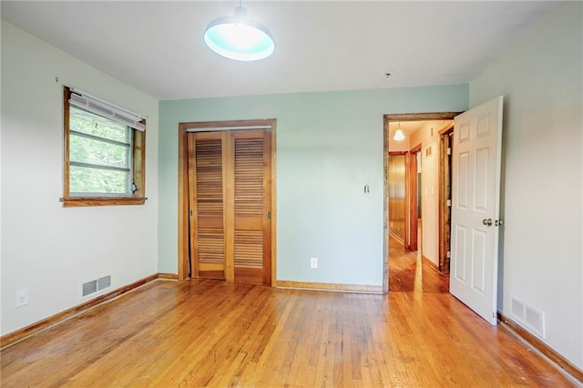 2201 Bollingbrook Dr, Atlanta, GA 30311 - unfurnished bedroom with light wood-type flooring, a closet, and baseboards