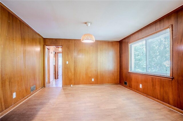 2201 Bollingbrook Dr, Atlanta, GA 30311 - empty room featuring wood finished floors, wood walls, ornamental molding, and baseboards