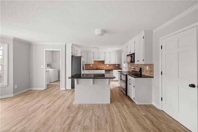 5659 Brookstone Dr NW, Acworth, GA 30101 - kitchen featuring appliances with stainless steel finishes, dark countertops, white cabinets, decorative backsplash, and a textured ceiling