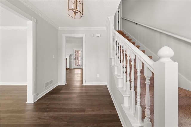 5659 Brookstone Dr NW, Acworth, GA 30101 - entrance foyer featuring dark wood-type flooring, a chandelier, baseboards, crown molding, and stairs