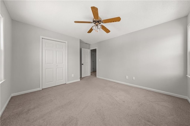 5659 Brookstone Dr NW, Acworth, GA 30101 - unfurnished bedroom featuring carpet floors, baseboards, a closet, and a ceiling fan