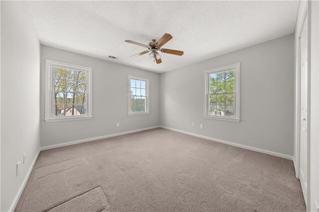5659 Brookstone Dr NW, Acworth, GA 30101 - carpeted spare room featuring healthy amount of natural light, a ceiling fan, a textured ceiling, and baseboards
