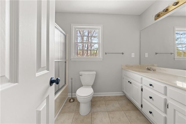 5659 Brookstone Dr NW, Acworth, GA 30101 - full bath with toilet, vanity, baseboards, tile patterned floors, and combined bath / shower with glass door