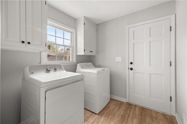 5659 Brookstone Dr NW, Acworth, GA 30101 - laundry area with cabinet space, washer and clothes dryer, light wood-style floors, baseboards, and a textured ceiling