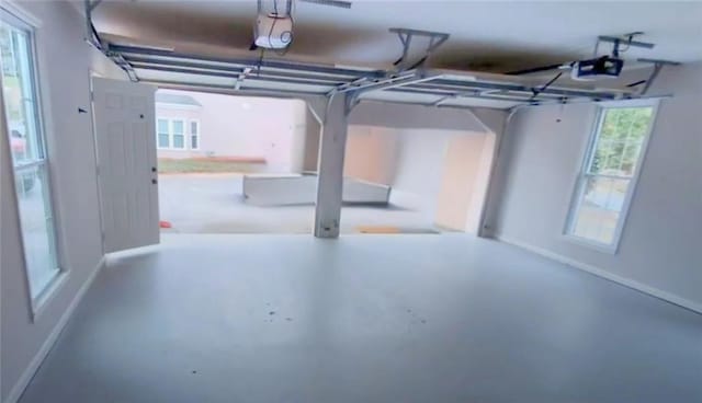 5659 Brookstone Dr NW, Acworth, GA 30101 - garage with a garage door opener and baseboards