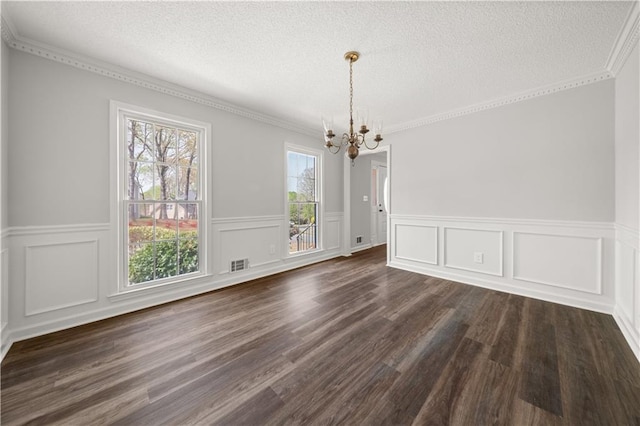 5659 Brookstone Dr NW, Acworth, GA 30101 - unfurnished dining area with a chandelier, a textured ceiling, a wainscoted wall, dark wood-style flooring, and a decorative wall