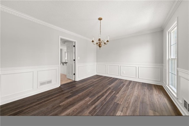 5659 Brookstone Dr NW, Acworth, GA 30101 - unfurnished dining area with a chandelier, a textured ceiling, a wainscoted wall, dark wood-style flooring, and ornamental molding