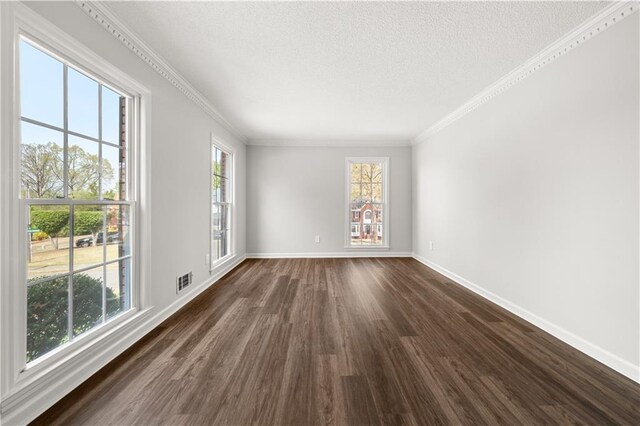 5659 Brookstone Dr NW, Acworth, GA 30101 - empty room with dark wood-type flooring, plenty of natural light, a textured ceiling, crown molding, and baseboards