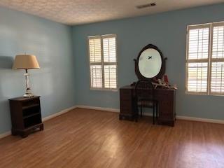 interior space with a wealth of natural light and hardwood / wood-style flooring