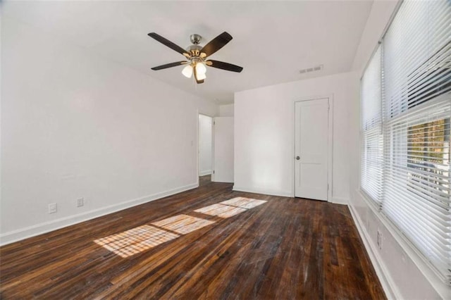 unfurnished bedroom with visible vents, wood-type flooring, baseboards, and ceiling fan