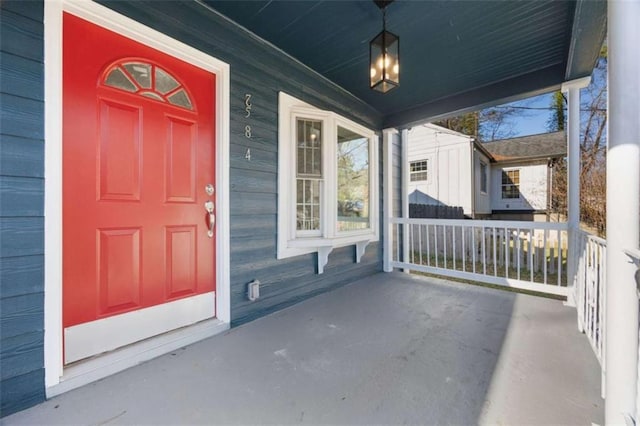 view of exterior entry with covered porch