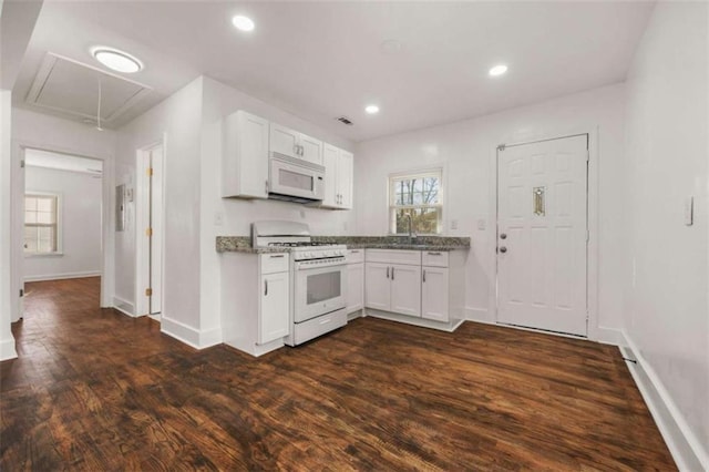 kitchen with recessed lighting, dark wood-style floors, white appliances, and white cabinets