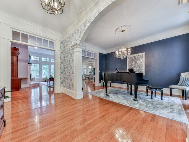 275 Frances Rd, Canton, GA 30114 - entryway featuring a chandelier, ornate columns, arched walkways, light wood finished floors, and ornamental molding