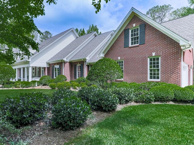 275 Frances Rd, Canton, GA 30114 - view of front of property with brick siding, a front yard, and a shingled roof