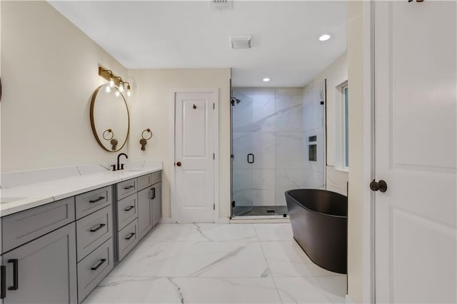 bathroom with vanity and shower with separate bathtub