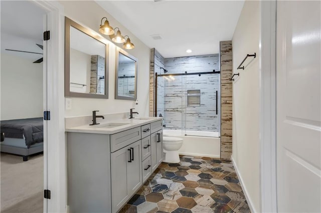 full bathroom featuring vanity, toilet, and combined bath / shower with glass door