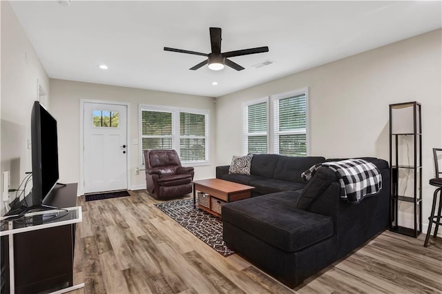 living room featuring hardwood / wood-style flooring and ceiling fan