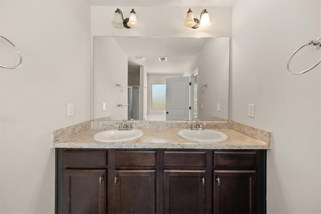 bathroom with an enclosed shower and vanity