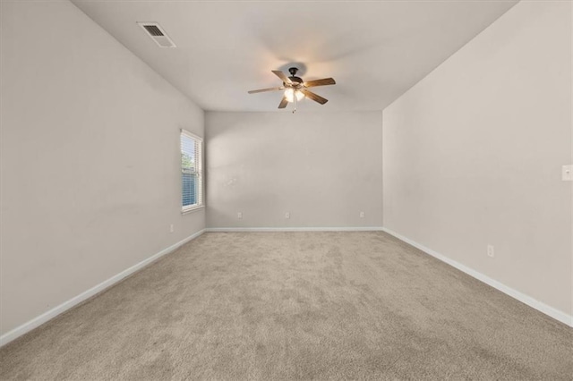 carpeted spare room featuring ceiling fan