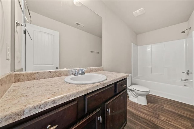 full bathroom with shower / bathtub combination, hardwood / wood-style flooring, vanity, and toilet