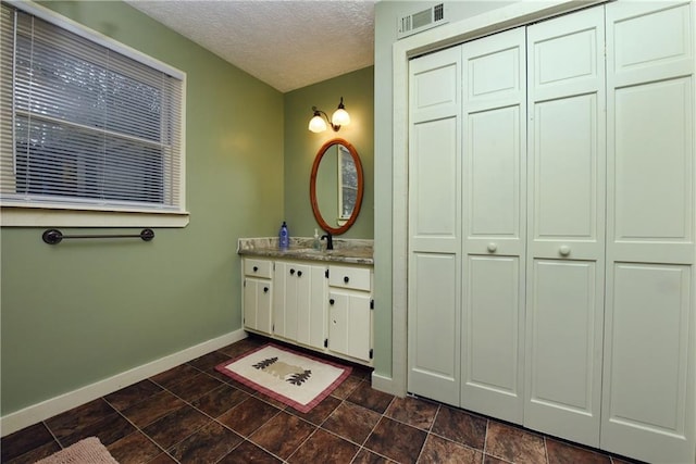 bathroom featuring vanity and a textured ceiling