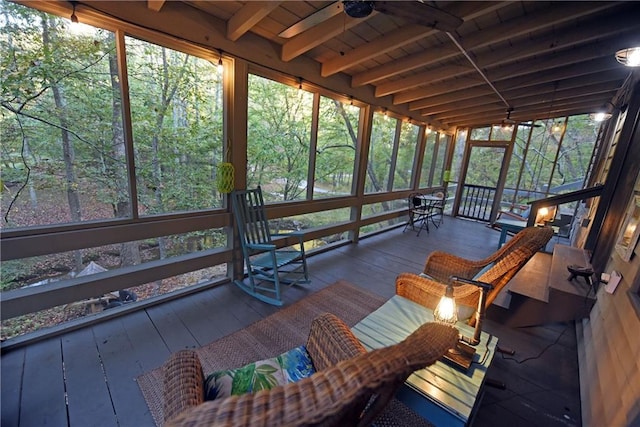 unfurnished sunroom featuring wood ceiling and beam ceiling