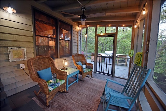 sunroom / solarium with ceiling fan, beamed ceiling, and wooden ceiling