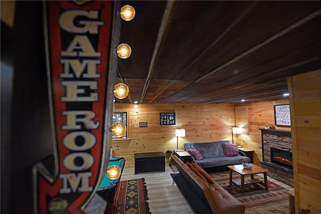 living room with a fireplace, wood walls, hardwood / wood-style floors, and wooden ceiling