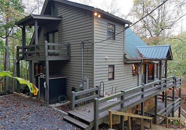 view of property exterior featuring a wooden deck