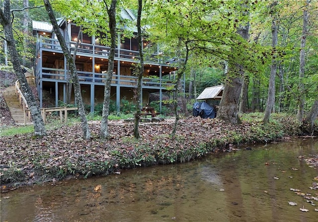 back of property featuring a water view