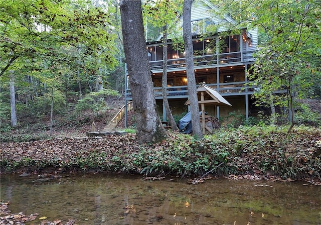 rear view of property with a water view