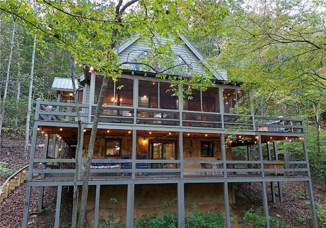 back of property featuring a wooden deck