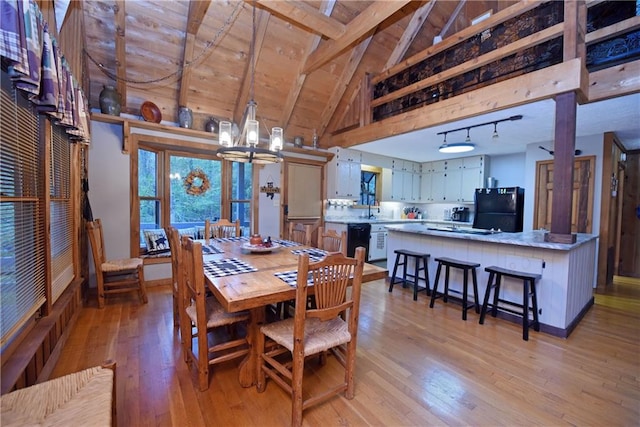 dining space featuring wood ceiling, beamed ceiling, light hardwood / wood-style flooring, and a notable chandelier