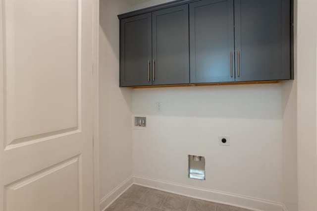 laundry area featuring hookup for a washing machine, cabinet space, baseboards, and hookup for an electric dryer