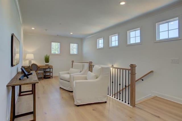 living room featuring recessed lighting, baseboards, plenty of natural light, and light wood finished floors