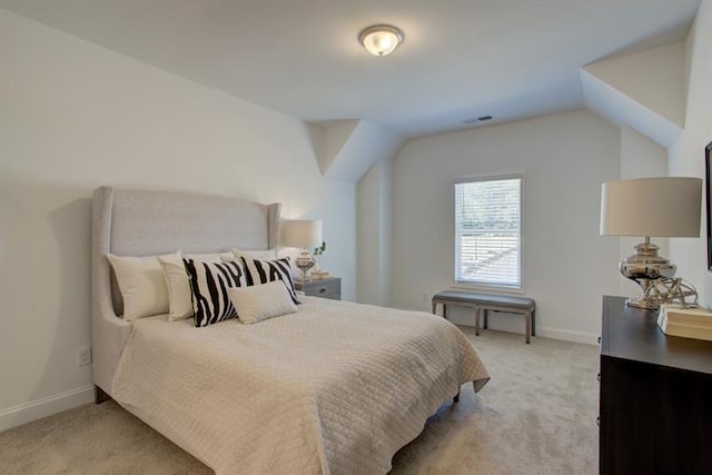 bedroom featuring visible vents, light colored carpet, and baseboards