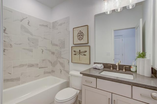 bathroom featuring washtub / shower combination, toilet, and vanity